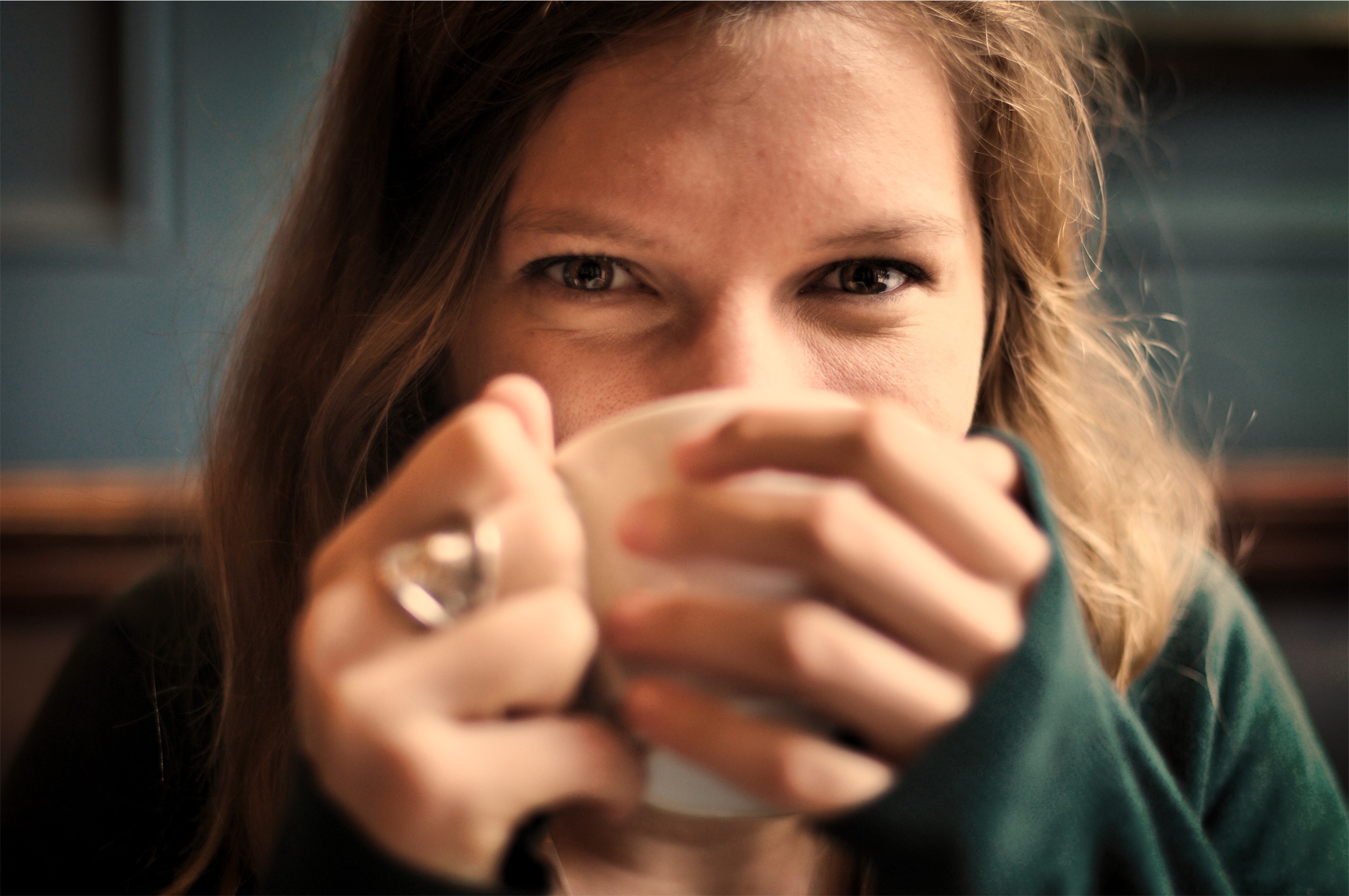 A woman enjoying a warm cup of coffee in a cozy Capitol Hill café, capturing the essence of Seattle’s vibrant coffee culture.